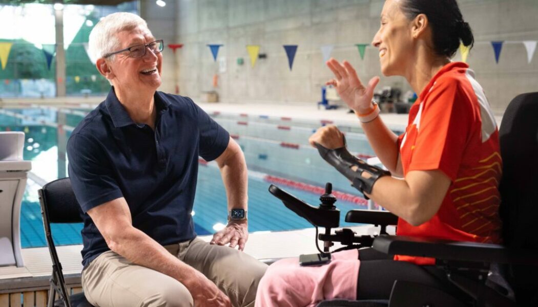 Apple CEO Tim Cook sat on a chair with a swimming pool in the background talking to Professional Paralympic Swimmer; Teresa Perales uses the Apple Watch for her insane training.