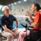 Apple CEO Tim Cook sat on a chair with a swimming pool in the background talking to Professional Paralympic Swimmer; Teresa Perales uses the Apple Watch for her insane training.